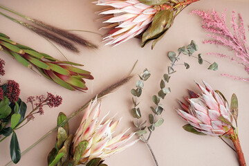 Composition with beautiful pink protea flowers on beige background - obrazy, fototapety, plakaty