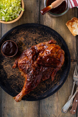 Half of smoked chicken with barbecue sauce served with salad and sauce