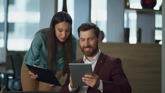 Smiling woman showing documents bearded realtor at comfortable lawyer cabinet