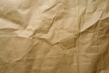 Obraz premium crinkled brown paper texture with a complex pattern of folds and creases.
