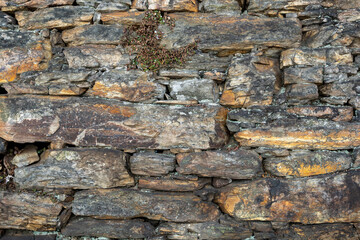texture of old stone wall made in the 17th century, in Ouro Preto, Brazil.