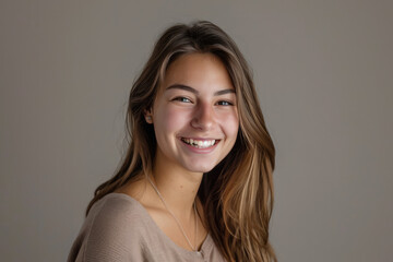 Fototapeta premium A young woman with long hair is smiling for the camera