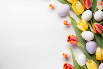 Easter background with spring flowers and colorful Easter eggs on white surface - obrazy, fototapety, plakaty