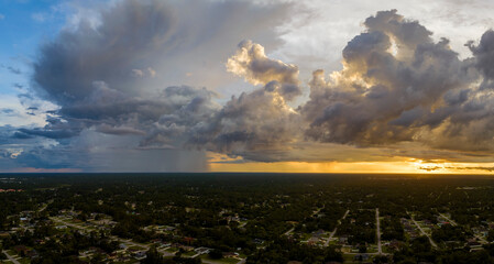 Landscape of dark ominous clouds forming on stormy sky during heavy thunderstorm over rural town...