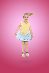 Happy cute girl jumping on color gradient background