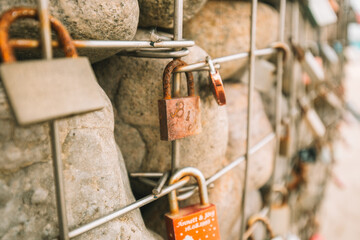 Metal locks on a grid with stones. Customs and traditions of lovers and newlyweds.Locks of lovers...