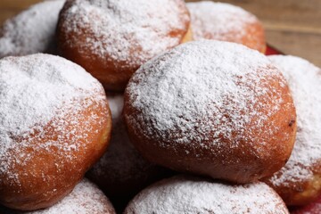 Fototapeta na wymiar Delicious sweet buns with powdered sugar, closeup