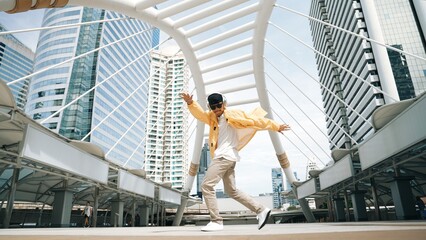 Stylish asian man perform hiphop dancing with low angle camera. Break dancer walking up the stair...