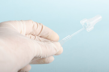Fibrin sealant. Equipment for surgery. Doctor with white gloves isolated on light blue background....
