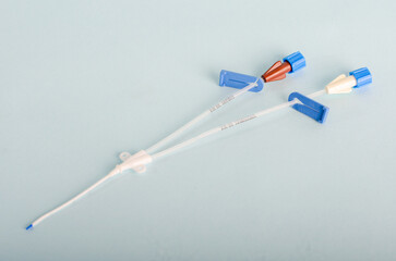 Central catheter kit elements, dilators, channeling needles. Instruments for surgery, surgery table, Isolated on light blue background, closed angle.