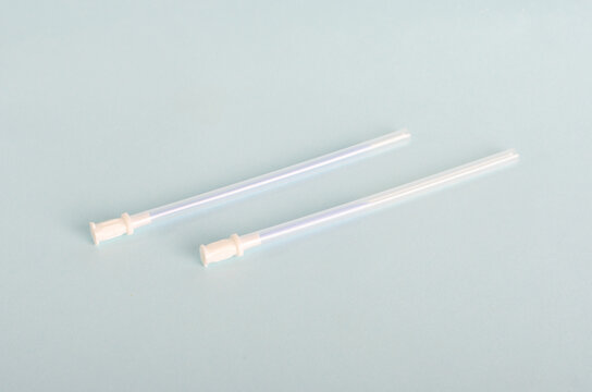Central catheter kit elements, dilators, channeling needles. Instruments for surgery, surgery table, Isolated on light blue background, closed angle.