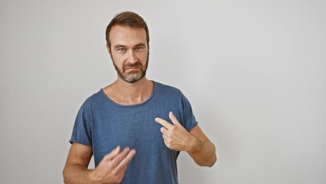 Middle-aged hispanic guy, confidently pointing and flashing a joyful smile against an isolated white background