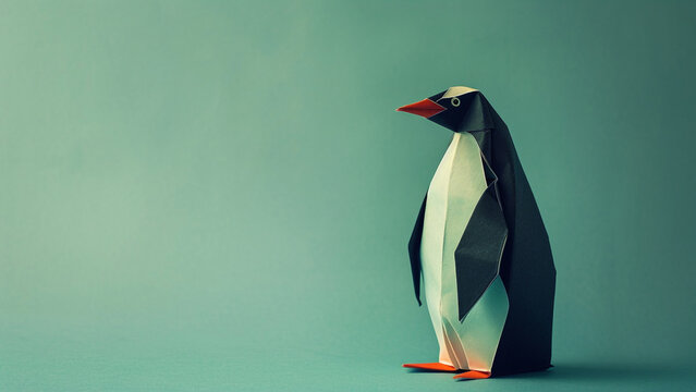 A paper origami wildlife animal of a emperor penguin on a plain colored background