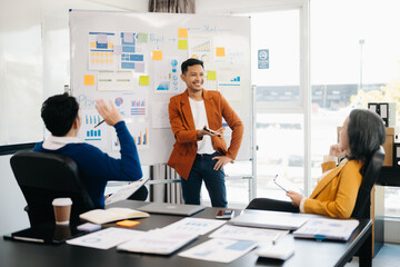 Asian business people sum up the results of their work in the company during the year, new project .