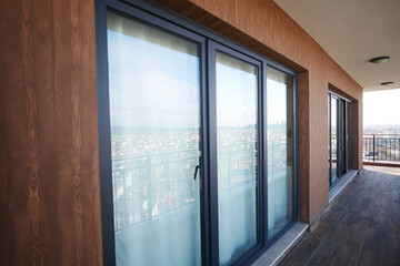 Fototapeta premium Modern front window with thin curtains and house walls from the outside view.