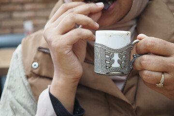  women drinking turkish coffee at cafe 