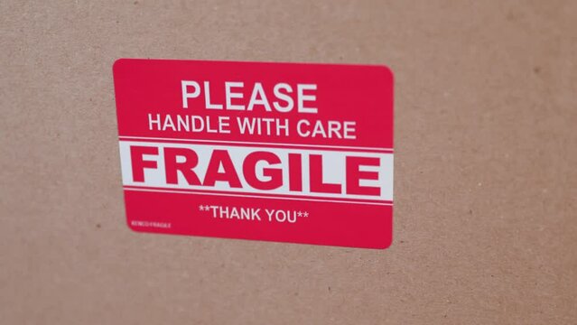 Please handle with care fragile sticker on shipping box