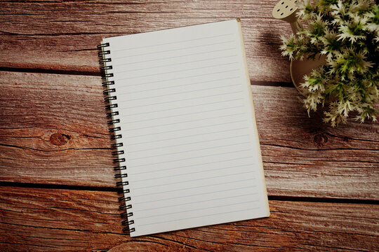 Empty Notebook open on wooden background