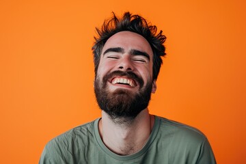 Laughing man in close up, joyful mood, orange studio