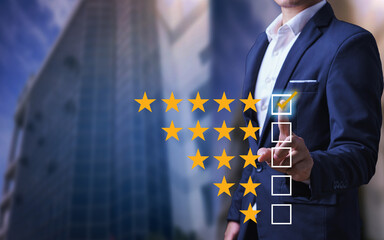 Businessman Close up on Customer Man hand with golden five star feedback icon and excellent rating...