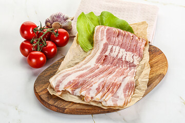 Sliced pork bacon oved board