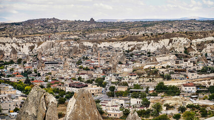Fototapeta na wymiar Panoramic view of Goreme town with characteristic cave hotels, unique rock structures and unique landscape a UNESCO world heritage site in the Cappadocia Region,Turkey.