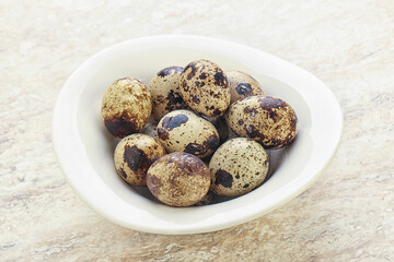 Raw quail eggs heap in the bowl