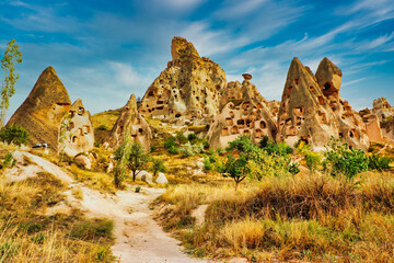 Uchisar Castle entrance path with view of the extensively hollowed out rock pillars, spires and caves leading to the top of the castle near  Goreme,Cappadocia Region,Turkey.
