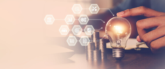 Hand choose light bulb with bright and icons for creative idea concept or innovation of technology in analyzing global marketing online business data management services to target growth concept.