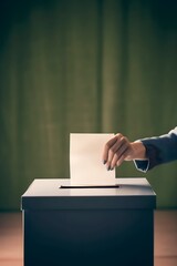 woman inserts election ballot into ballot box