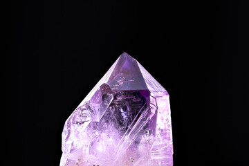 amethyst crystal isolated on black background. macro detail close-up rough raw unpolished...
