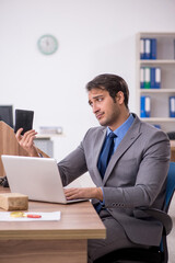 Naklejka premium Young male employee in remuneration concept