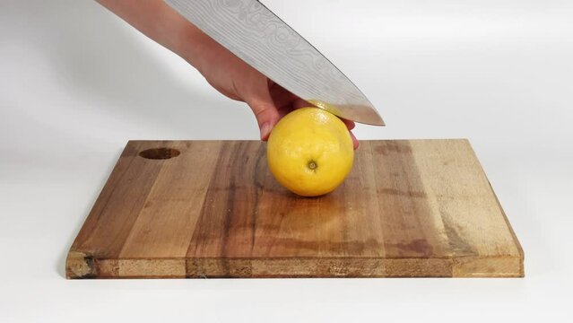 Slicing a Lemon on Cutting Board
