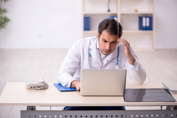 Young male doctor in telemedicine concept