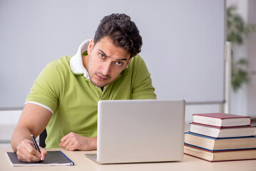 Young male student in telestudying concept