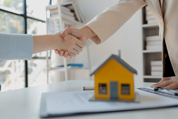 real estate broker manager hand shake to customer after signing contract for buying house, investment, buy and sell house concept, Real estate professionals and clients discussing home purchases,
