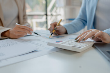 Calculate the numbers according to the report sent to the meeting, They are calculating the taxes they have to pay, They are having a meeting about the company's income and expenses,