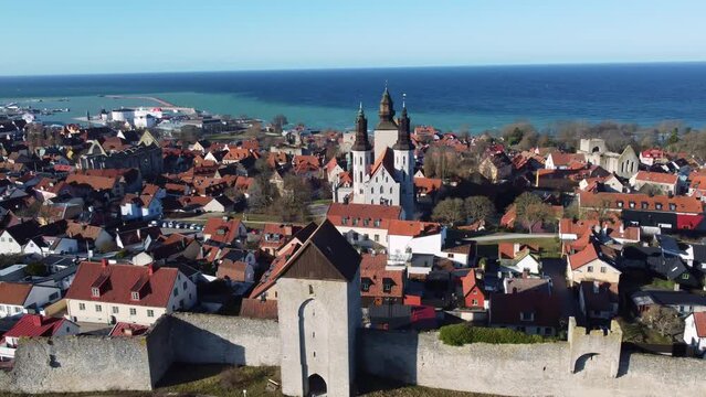 Visby, Sweden: Aerial drone footage of the Dalman gate and fortified wall in Visby old town with the cathedral in Gotland island in Sweden in the Baltic sea