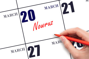 March 20. Hand writing text Nowruz on calendar date. Save the date.