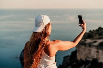 Selfie woman in cap and tank top making selfie shot mobile phone post photo social network outdoors...