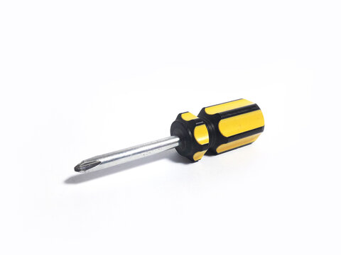 Yellow mini screwdriver and screws, isolated white background, made of iron and plastic