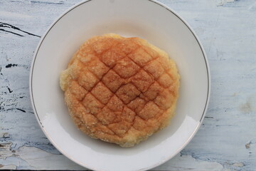 Bread sprinkled with granulated sugar in a plate on the table