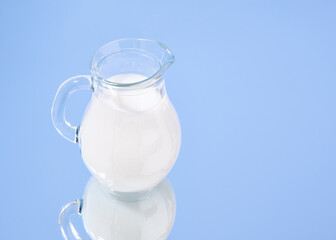 A glass jug of fresh cow's milk. Copy space for text.
