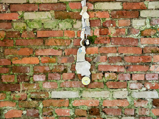 Old brick wall of an abandoned house with peeling paint. Vintage texture or background