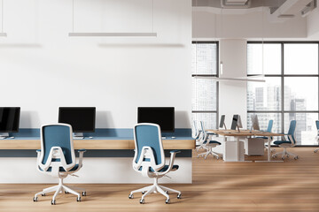 Office coworking interior with pc computers and armchairs in row, window