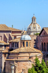 View of rooftops and the domes of  the Temple of Romulus or Tempio di Romolo and Dome of Saint Luke and Martina Church or Chiesa dei Santi Luca e Martina in Rome, Italy.
