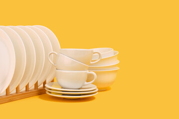 Set of kitchen ceramic tableware on a yellow background. Copy space for text.