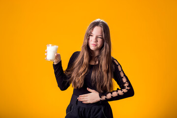 Girl with glass of milk doesn't like it. Dairy Intolerant person. Lactose intolerance, health care...