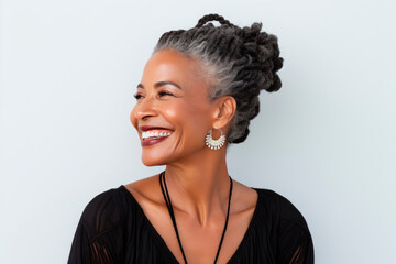 Elderly black woman with smooth healthy facial skin. Beautiful aging mature woman with gray hair, dreadlocks, happy face. Concept of advertising beauty and cosmetics for women's skin care. Copy space - obrazy, fototapety, plakaty