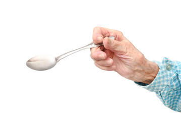 The hand of a 95-year-old elderly woman holds a spoon, isolated on a white background.Rheumatoid...